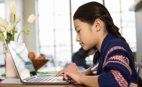 Child working on laptop at home