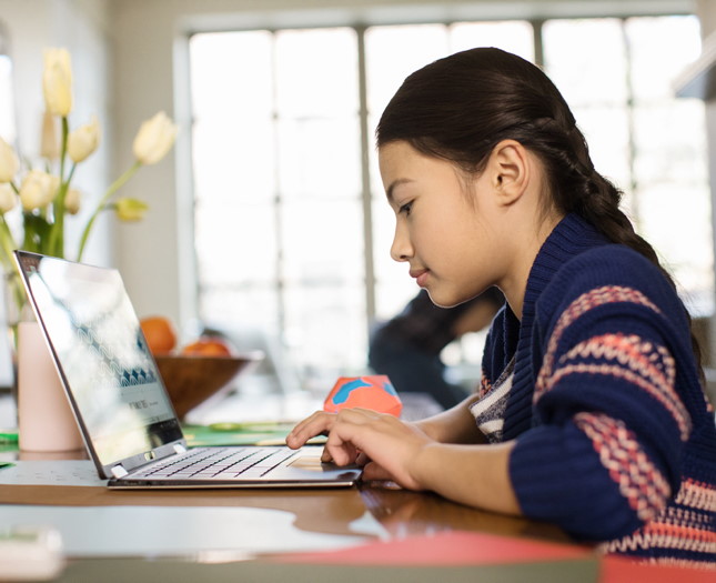 Child working on laptop at home