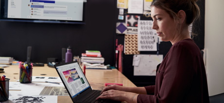 Person at a desk working on a laptop