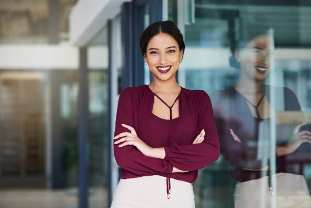 A recent hire smiles in the lobby of their new office