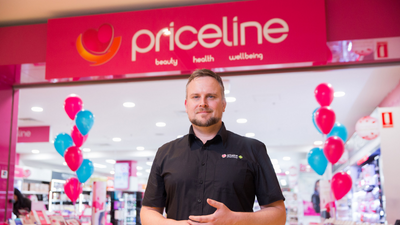 Man standing in front of Priceline store