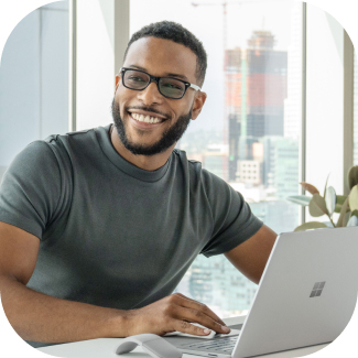 A person looking up from a laptop