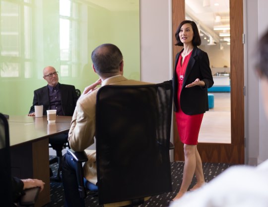 A woman standing in a meeting room