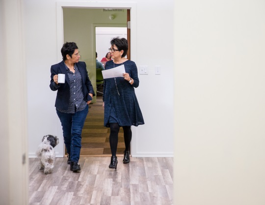 Two women walking in a hallway