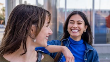 Two people smiling at each other.