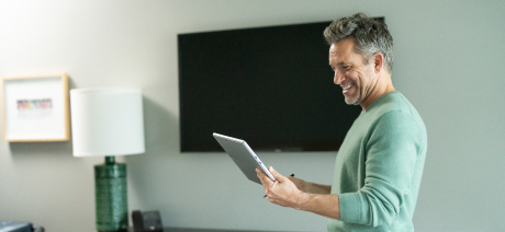 An executive reads pleasing news on his tablet