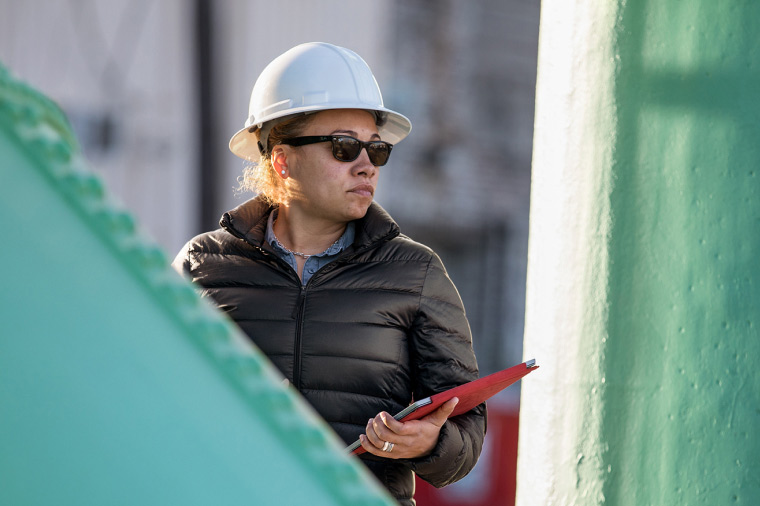A manager oversees a project in the field