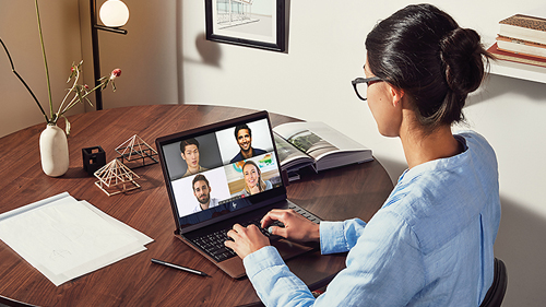 Person using Microsoft Teams at their table
