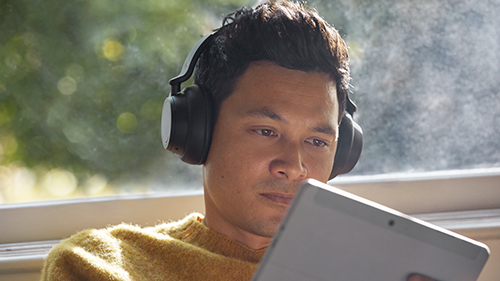 Person using a tablet with headphones