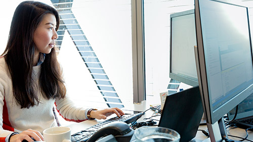 Woman working at desk next to window