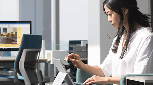 Woman at desk using Surface tablet