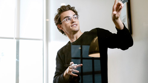 Man pointing behind him