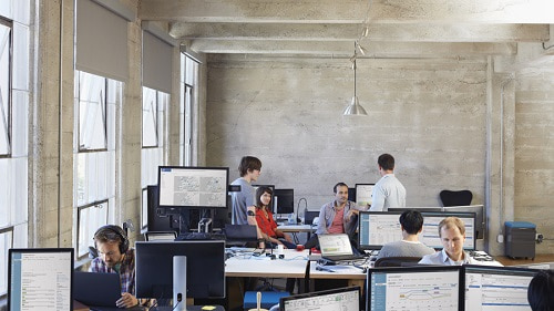 People working in an open office with computers