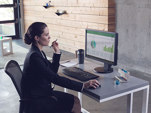 Woman working at desk on computer
