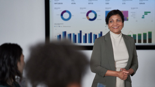 Women presents security topics in a conference room setting