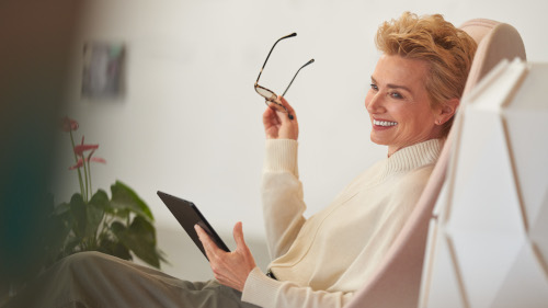 Businesswoman holding a tablet while working from home