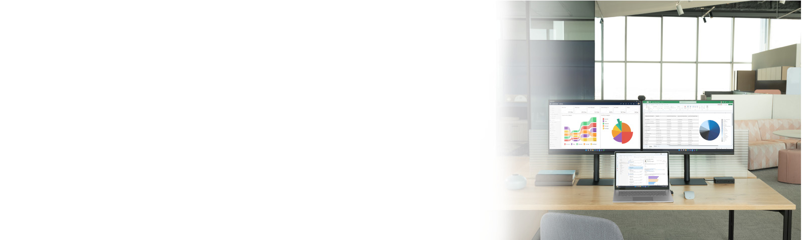 Office desk with Laptop and two screens showing Dynamics 365