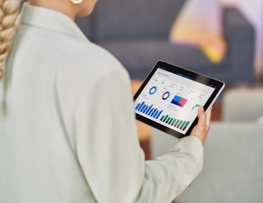 Women holding a tablet open with Dynamics 365