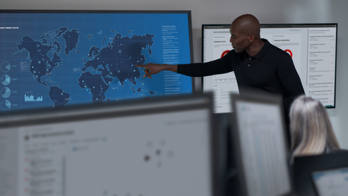 Female speaker presenting in a conference room with remote attendees