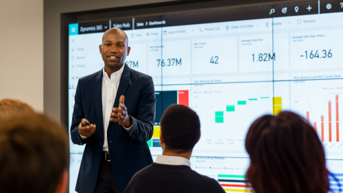 CFO presenting sales results to large group meeting