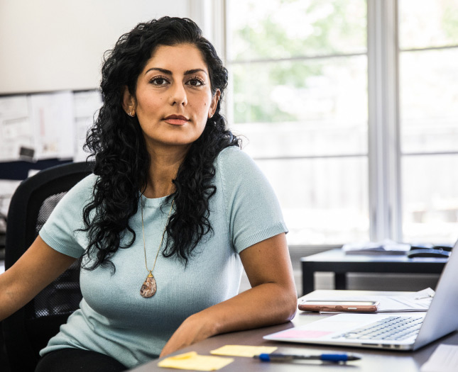 A woman at her desk in a casual office