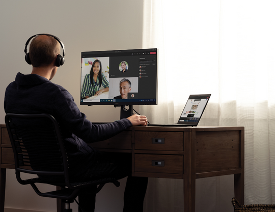 A man working from home and participating in a virtual meeting
