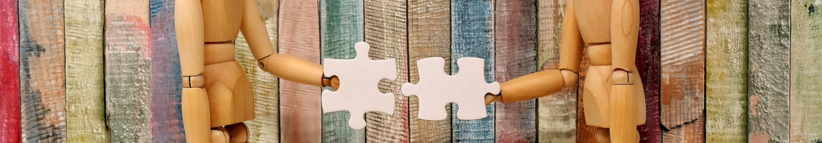  two wooden sculptures playing puzzle