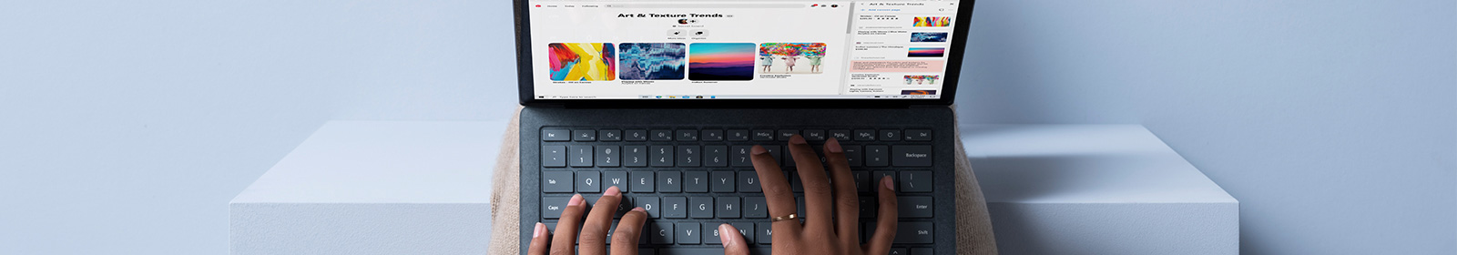 The photo shows a woman sitting with the laptop on her lap.