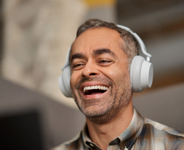 A laughing man with headphones