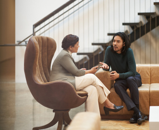 A man and a woman comfortably seated and talking