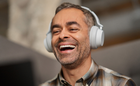 A laughing man with headphones