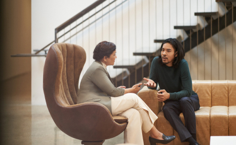 A man and a woman comfortably seated and talking