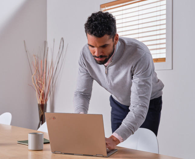 A professional works on their laptop