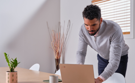 Man in a meeting room working on his laptop