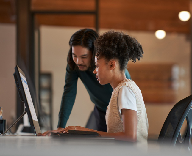 A man and a woman looking at monitor