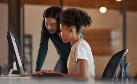 A man and a woman looking at monitor