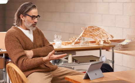 A man having a virtual meeting on his tablet