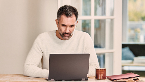 Man at table using laptop