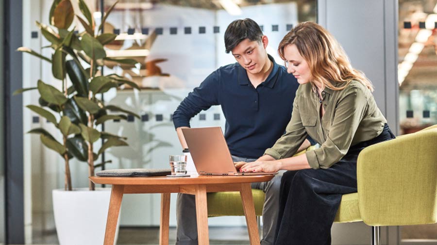 Man and woman looking at a laptop
