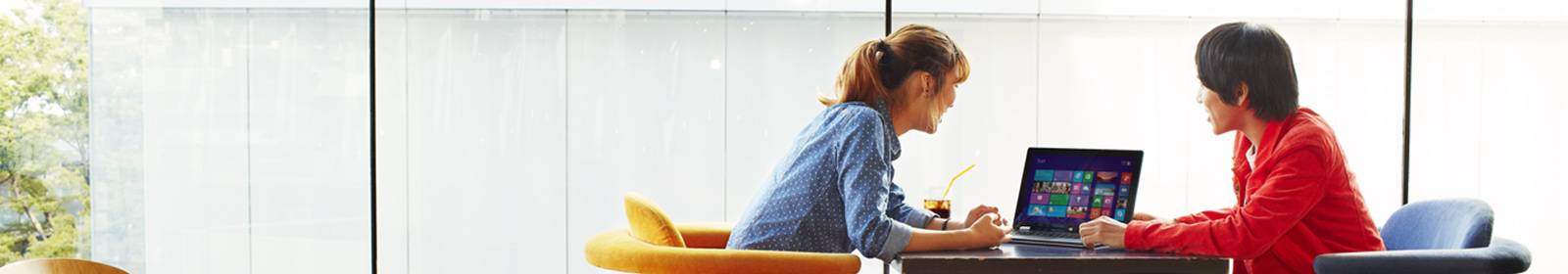 Two people look at a tablet together