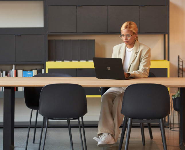 A woman working on her laptop at the office