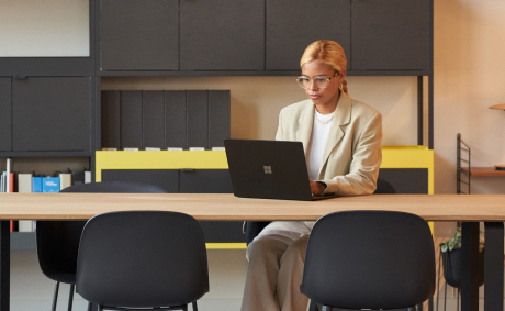 A woman working on her laptop at the office