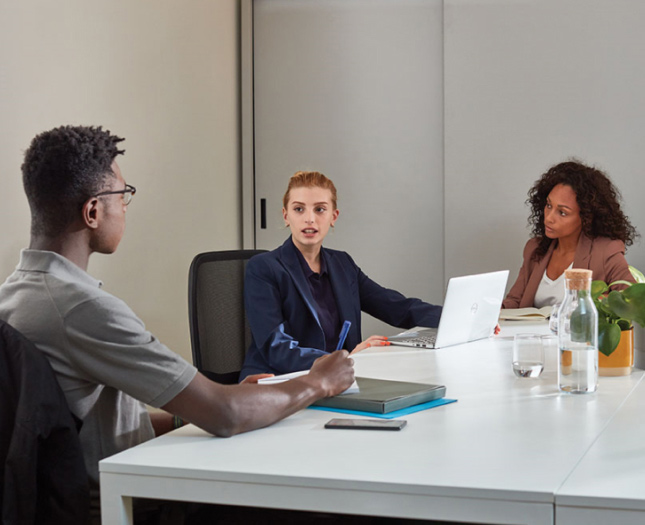 Three people in a meeting at a conference room