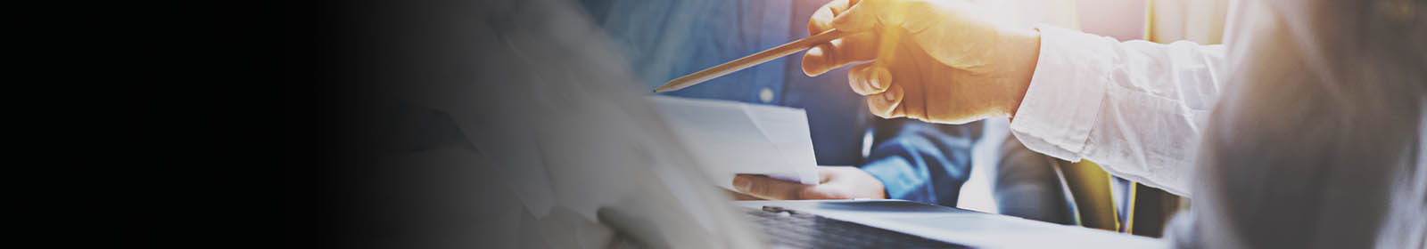 Hand with pencil pointing at data