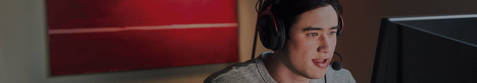 Man wearing headphones using a computer