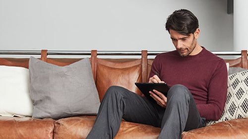 Person sitting on a couch using a tablet