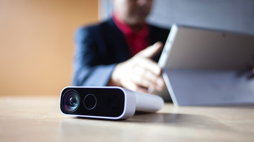 Webcam in foreground with person in background on tablet