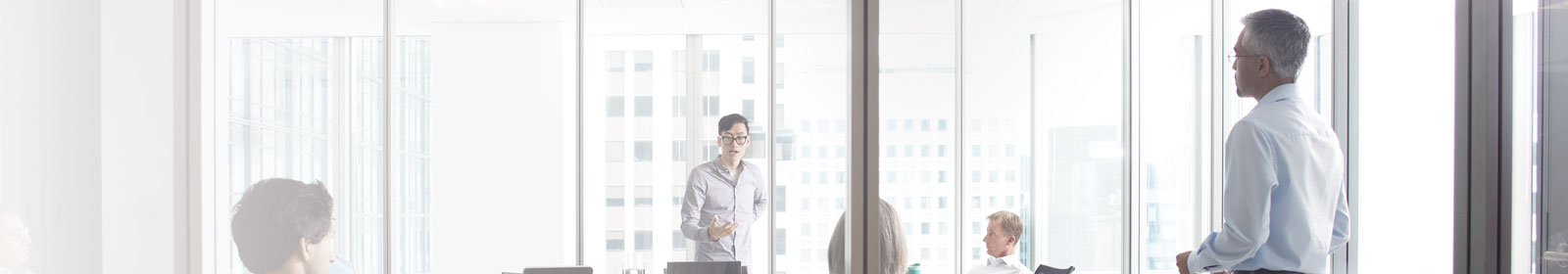Man talks to his peers in a boardroom