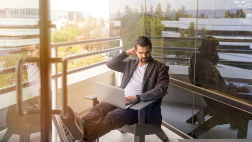 person sitting with laptop