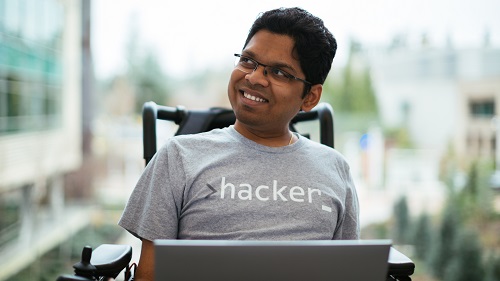 A man with a laptop sitting in his wheelchair